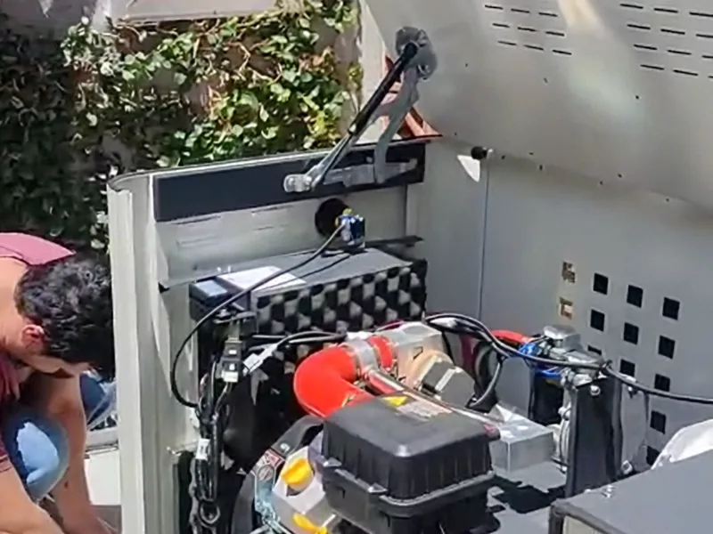 Planta estacionaria abierta durante la conexión, con el motor y el cableado a la vista